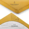 A close-up view of a yellow fitted sheet, showing its texture and elastic band. Produktbild-Vorschau