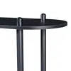 A close-up view of the top of a black shelf unit, showing two cylindrical supports on the surface. Náhled obrázku produktu