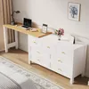 A bedroom scene with a white dresser and a wooden desk attached. Podgląd zdjęcia produktu