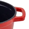 A close-up view of the handle and interior of a red pot. Produktbild-Vorschau