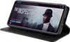 A smartphone in a black flip case is displayed on a surface, showing a movie streaming interface on its screen. Produktbild-Vorschau