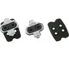 Three bicycle pedal cleats and a rubber cleat cover are arranged on a white background. Produktbild-Vorschau