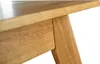 A close-up view of the wooden leg and underside of a table. Produktbild-Vorschau