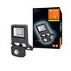 A product shot of a floodlight with a motion sensor next to its packaging. Produktbild-Vorschau