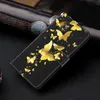 A black flip phone case with a gold butterfly design is shown on a dark surface. Produktbild-Vorschau