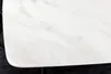 A close-up view of a white marble-patterned tabletop with rounded corners, resting on black legs. Produktbild-Vorschau