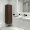 A modern bathroom with a tall, dark brown cabinet and a white vanity with a sink. Anteprima dell’immagine prodotto
