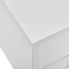A close-up view of the corner of a white nightstand, showing the top surface and a drawer front. Podgląd zdjęcia produktu