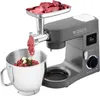 A kitchen mixer with a meat grinder attachment is shown, grinding meat into a bowl. Produktbild-Vorschau