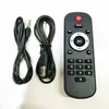 A remote control and two cables are laid out on a white background. Produktbild-Vorschau