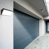 A modern garage door and exterior wall with lighting. Produktbild-Vorschau