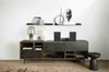A modern living room setup featuring a stereo system on a media console, with decorative items on shelves above. Podgląd zdjęcia produktu