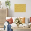 A living room scene with a sofa, coffee table, and wall art. Podgląd zdjęcia produktu