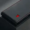 A close-up shot of a black leather flip phone case with red stitching and a red bull logo. Anteprima dell’immagine prodotto