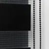 A close-up view of a black and white striped roller blind with beaded pull cords. Produktbild-Vorschau