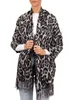A woman wearing a leopard print scarf. Produktbild-Vorschau