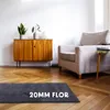 A dark grey rug is placed on a wooden floor in a living room setting, next to a wooden cabinet and an armchair. Anteprima dell’immagine prodotto