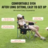 A man sitting in a camping chair outdoors on grass. Produktbild-Vorschau