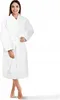 A woman is standing and modeling a white bathrobe. Náhled obrázku produktu