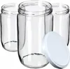 Three empty glass jars with a white lid in the foreground. Podgląd zdjęcia produktu