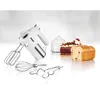 A white hand mixer is displayed alongside baked goods and whipped cream, suggesting baking and dessert preparation. Anteprima dell’immagine prodotto