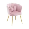 A pink velvet armchair with gold legs and a small bow-shaped pillow. Produktbild-Vorschau