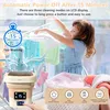 A young girl is hanging laundry on a drying rack next to a portable washing machine. Produktbild-Vorschau