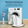 A washing machine with a white towel being pulled out, next to a vase with cotton branches and a basket. Náhled obrázku produktu