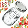 A clear glass jar with a silver lid, surrounded by fresh vegetables and herbs. Produktbild-Vorschau