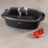 A black roasting pan with a glass lid sits on a gray surface, with a sprig of cherry tomatoes to the right. Podgląd zdjęcia produktu