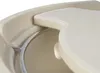 A close-up view of a beige-colored accessory attached to a grill. Produktbild-Vorschau