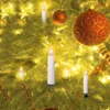 Close-up of Christmas tree decorations, including LED candles and ornaments. Produktbild-Vorschau