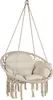 A beige macrame hanging chair with cushions, suspended by ropes against a white background. Voir les images du produit