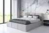 A modern bedroom with a large bed, marble walls, and large windows.