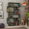 A modern bookshelf filled with books and decorative items, placed against a textured wall. Náhled obrázku produktu