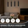A living room scene with a sofa, coffee table, television, and pendant lights. Four different light bulbs are displayed in circles at the bottom. Anteprima dell’immagine prodotto