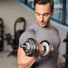 A man is lifting a dumbbell in a gym. Náhled obrázku produktu