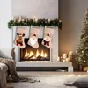 Christmas stockings hanging on a fireplace mantel above a lit fireplace, with a Christmas tree in the background. Produktbild-Vorschau