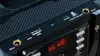 Close-up view of the control panel of a portable Bluetooth speaker, showing various ports and buttons. Produktbild-Vorschau