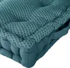 A close-up view of a teal floor cushion with a diamond pattern. Produktbild-Vorschau