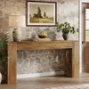 A wooden console table with decorative elements is placed against a stone wall. Podgląd zdjęcia produktu
