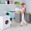 A woman is doing laundry in a laundry room. Náhled obrázku produktu