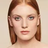 Close-up portrait of a woman with red hair wearing makeup. Produktbild-Vorschau