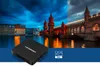 A Blaupunkt Android TV box is placed in front of a split image of a city skyline at dusk. Produktbild-Vorschau