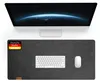 A computer monitor and a desk mat with a keyboard and mouse on it. Produktbild-Vorschau