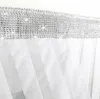 A close-up view of the top edge of a white curtain with a decorative silver trim. Podgląd zdjęcia produktu