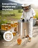 A beekeeper in a protective suit is using a manual honey extractor outdoors, with jars of honey and frames visible. Anteprima dell’immagine prodotto