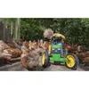 A young child is playing with a green pedal tractor toy surrounded by chickens. Podgląd zdjęcia produktu