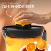 A person is using an electric citrus juicer to make orange juice. Produktbild-Vorschau