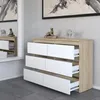 A modern dresser with white drawers and a wood-effect top, set against a textured gray wall and a large mirror. Produktbild-Vorschau